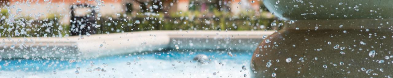 A close up of the fountain outside of the Student Services Building with water droplets suspended